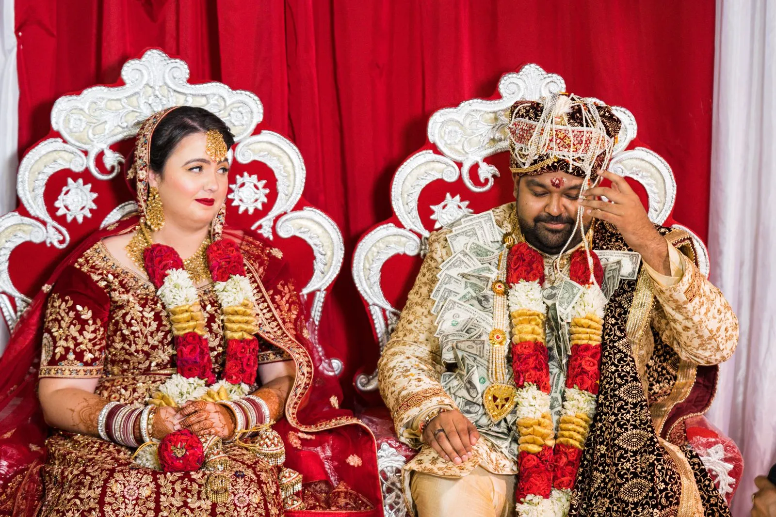Beautiful Indian couple in traditional attire during a vibrant wedding ceremony indoors.